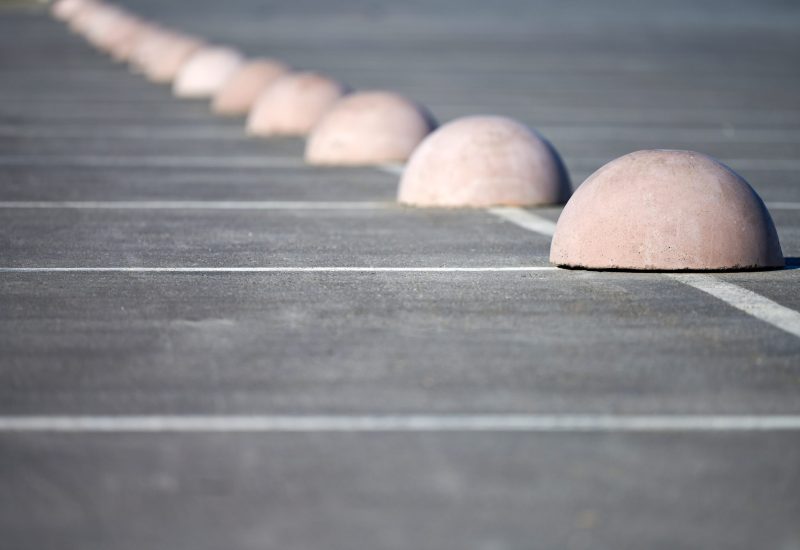 Concrete hemispheres parking limiter. Protection from car parking. Elements to restrict access to parking zone and control movement of vehicles